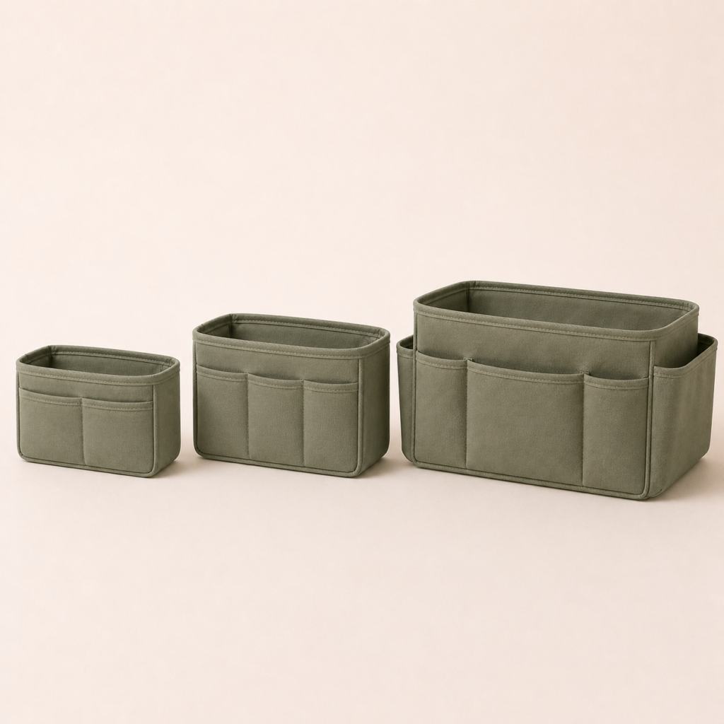 Small, medium and large sage green room organizer pouches on a clean neutral background